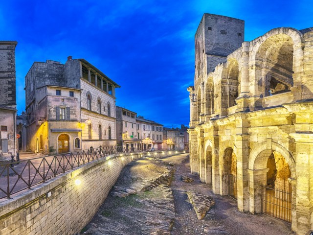Medieval architecture and stone streets of Arles, France, seen at night