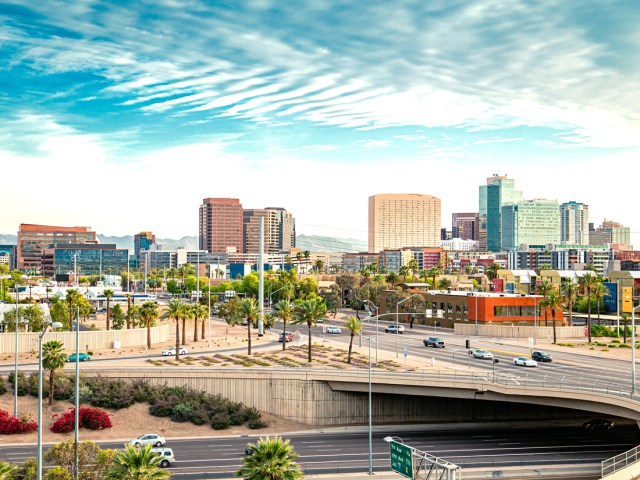 Highway interchange in Phoenix, Arizona, with high-rise buildings in the distance