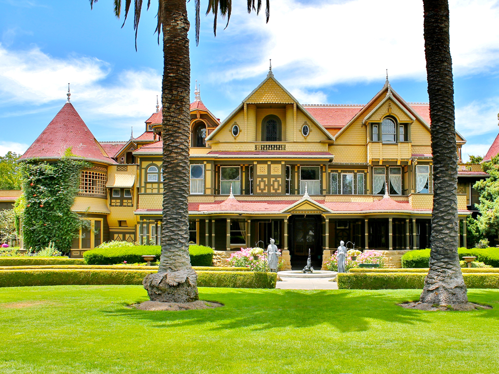 Yellow exterior of Winchester Mystery House in San Jose, California