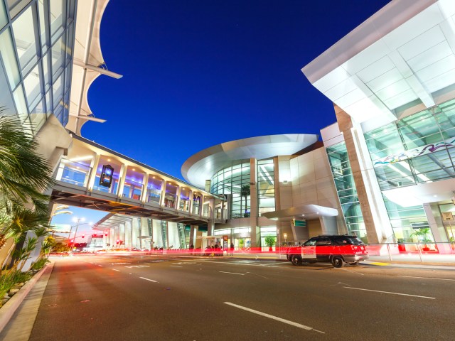 Passenger drop-off area in front of terminal building, seen at night, at San Diego International Airport