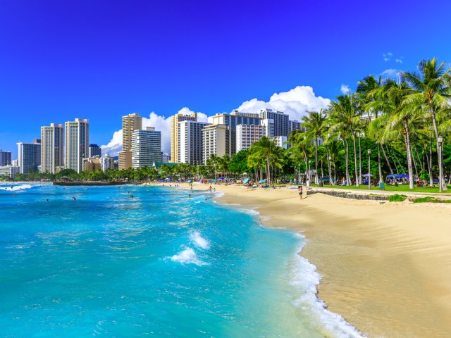 Sandy beach with Honolulu, Hawaii, skyline behind