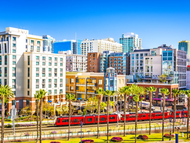 Red tram running through downtown San Diego, California