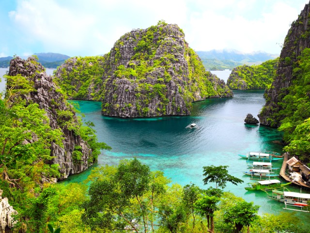 Lush islands and boats docked in marina in Palawan, Philippines 