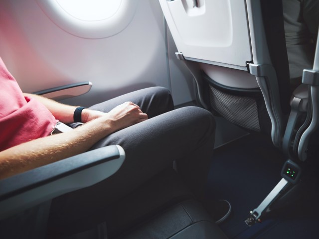 Passenger seating in window seat on airplane