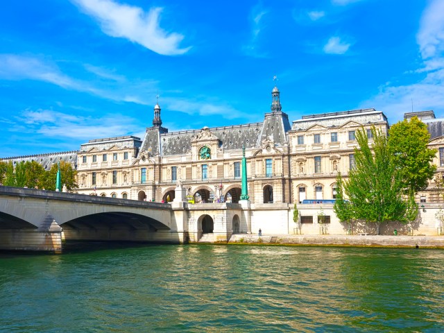 Exterior of the Louvre museum in Paris, France, seen across Seine River