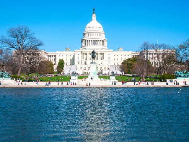 United States Capitol Building seen across Capitol Reflecting Pool in Washington, D.C.