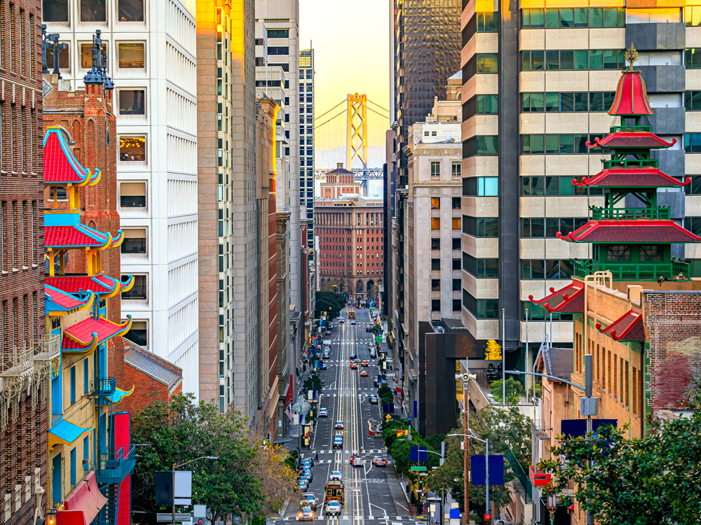 View of Bay Bridge between high-rise buildings in downtown San Francisco