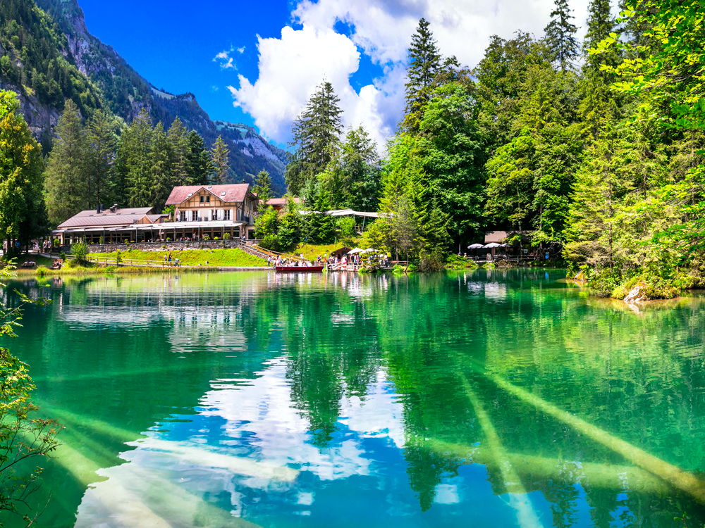 Lake Blausee in Switzerland framed by the Alps