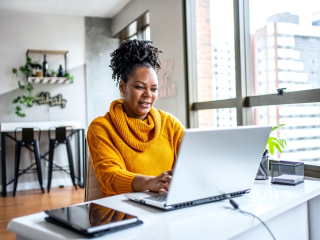 Woman typing on laptop computer