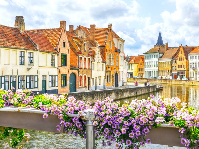 Flowers covering bridge over canal in Bruges, Belgium