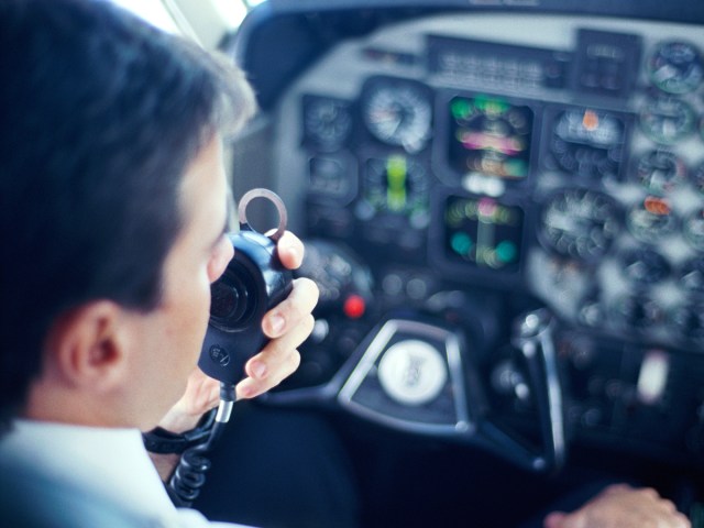 Pilot in cockpit making announcement over PA