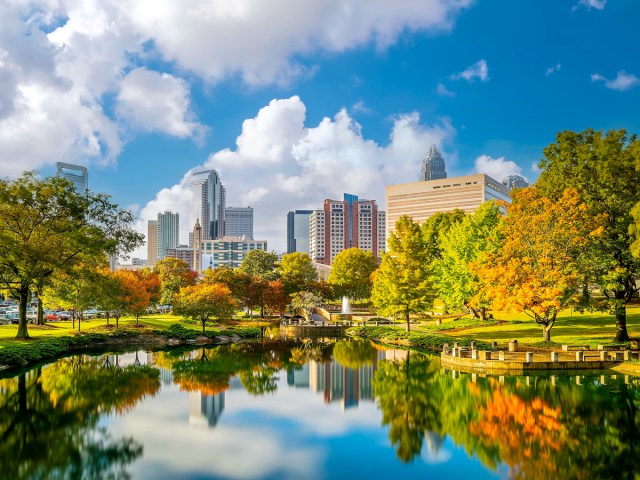 Cityscape of Charlotte, North Carolina, with reflection in park pond