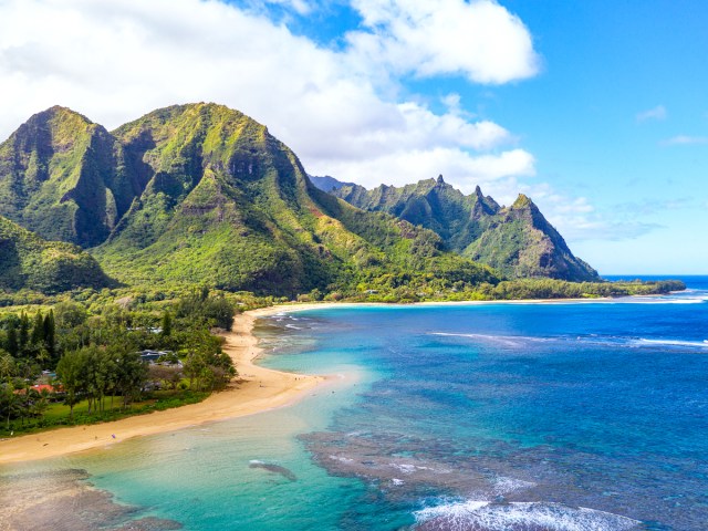 Aerial view of Kauai's Napali Coast with dramatic, lush cliffs