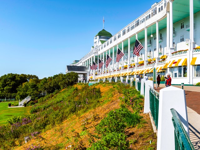 American flags flying over wraparound porch of Grand Hotel on Mackinac Island in Michigan