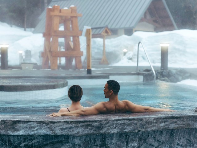 Couple relaxing in hot springs at Alyeska Resort near Anchorage, Alaska