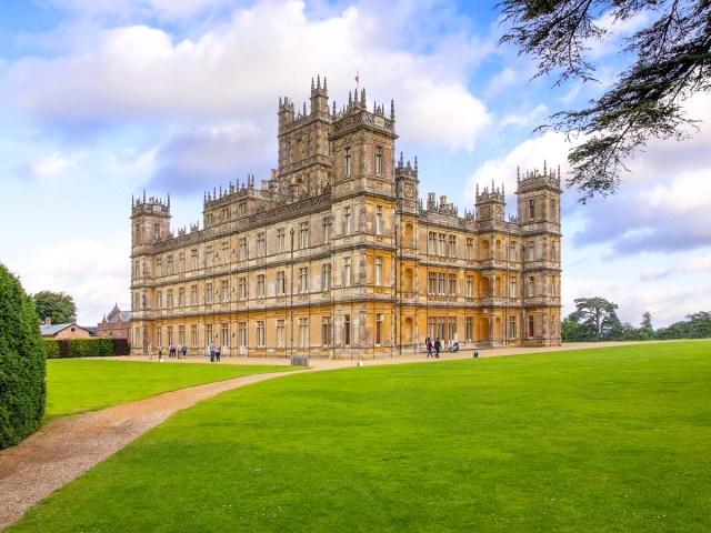 Visitors walking around Highclere Castle and grounds in England