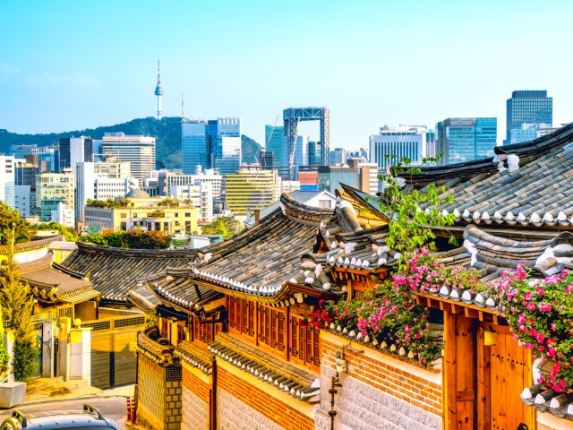 Traditional homes with modern skyscrapers in distance in Seoul, South Korea