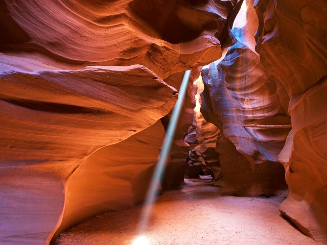 Narrow beams of light reaching floor of Antelope Canyon in Arizona