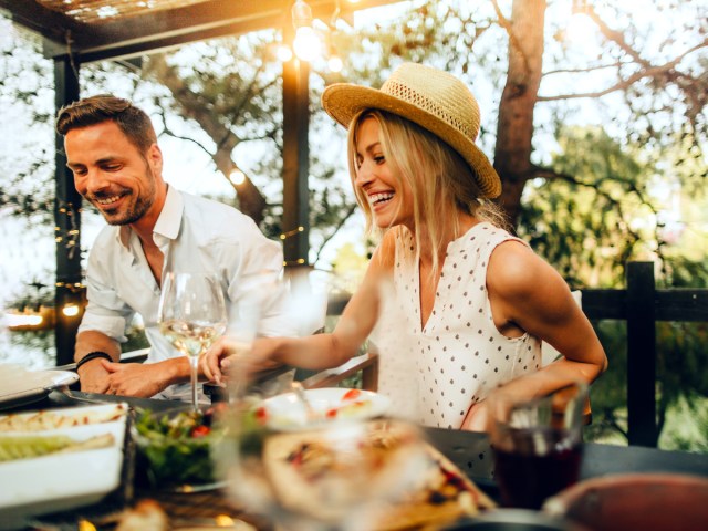 Man and woman smiling and enjoying meal