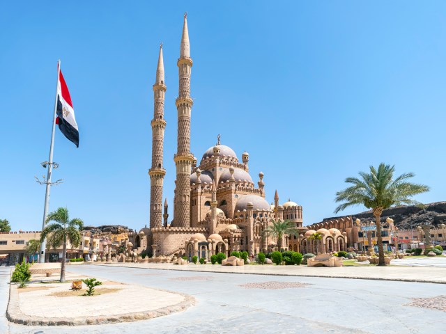 Egyptian flag flying in front of mosque in Sharm El Sheikh, Egypt