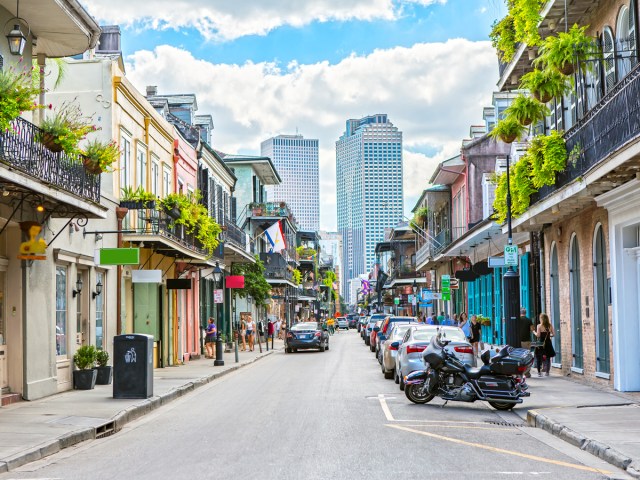 Street in New Orleans' French Quarter with view of modern skyscrapers in distance