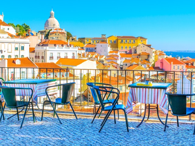 Patio with empty tables and chairs overlooking Lisbon, Portugal