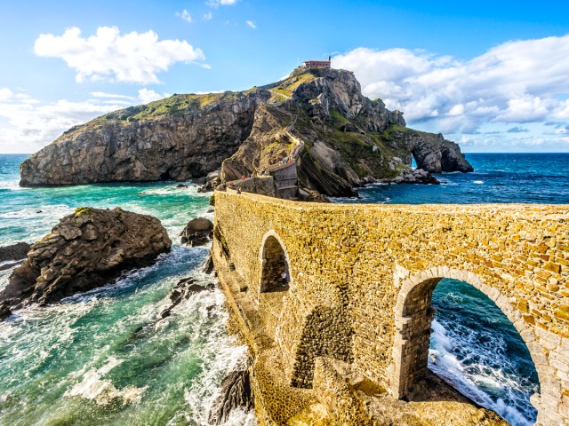 Stone arched bridge leading to San Juan de Gaztelugatxe off the coast of northern Spain