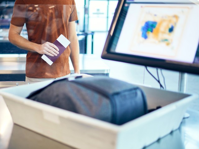 Traveler's backpack in security bin at airport