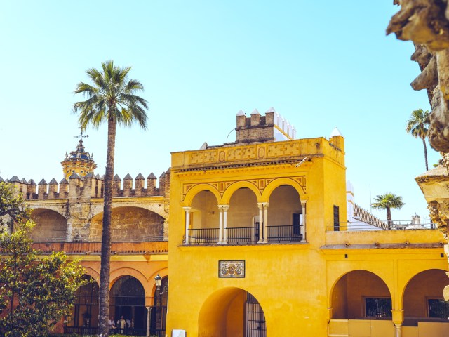 Yellow facade of the Royal Alcázar of Seville, Spain