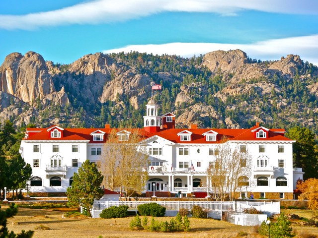 Colorado's historic Stanley Hotel framed by mountains in background