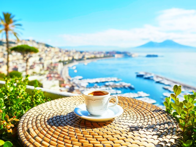 Cup of espresso on table overlooking the Italian coastline