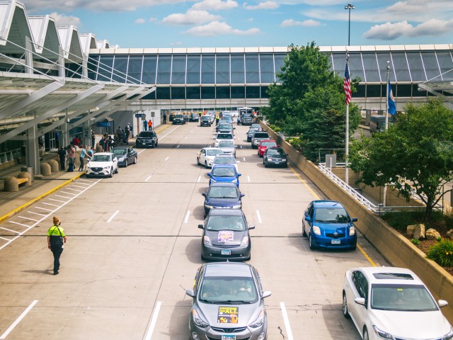 Cars lined up on roadway next to passenger terminal at Minneapolis-St. Paul International Airport in Minnesota