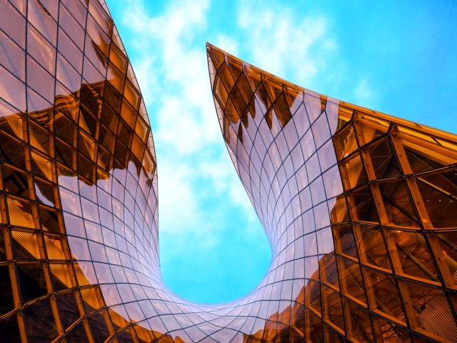 Curving, amber-hued glass facade of the Emporia Shopping Center in Malmö, Sweden