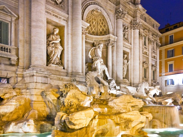 View of statues above Trevi Fountain at night