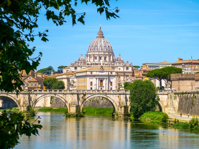 St. Peter's Basilica in distance, seen across Tiber River in Rome, Italy