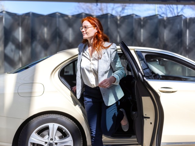 Woman stepping out of car