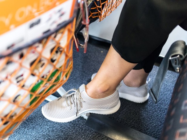 Close-up view of airline passenger's feet underneath seat