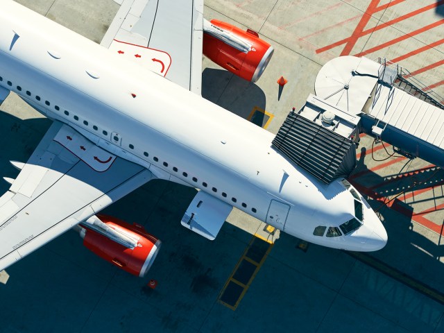 Airplane parked at gate, seen from directly above