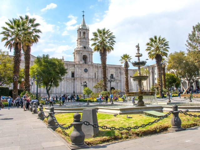 People gathering in Plaza de Armas in front of Cathedral Basilica of Arequipa, Peru 