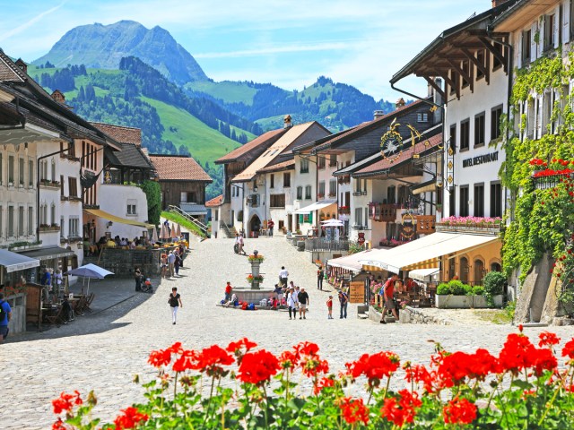 Pedestrians walking through alpine village in Switzerland