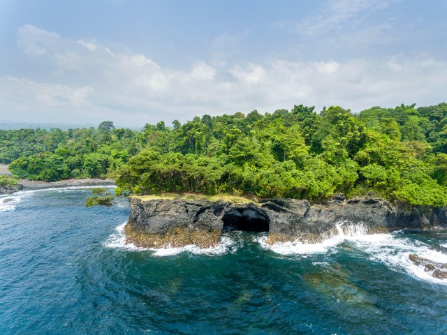 Aerial view of coastal cliffs and lush greenery in San Antonio de Ureca, Equatorial Guinea