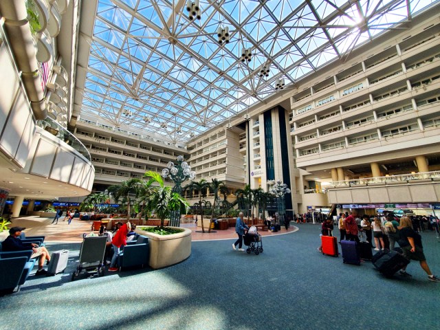 Passengers inside light-filled terminal at Orlando International Airport in Florida