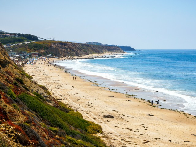 Beach goers on sandy beach in Crystal Cove, California