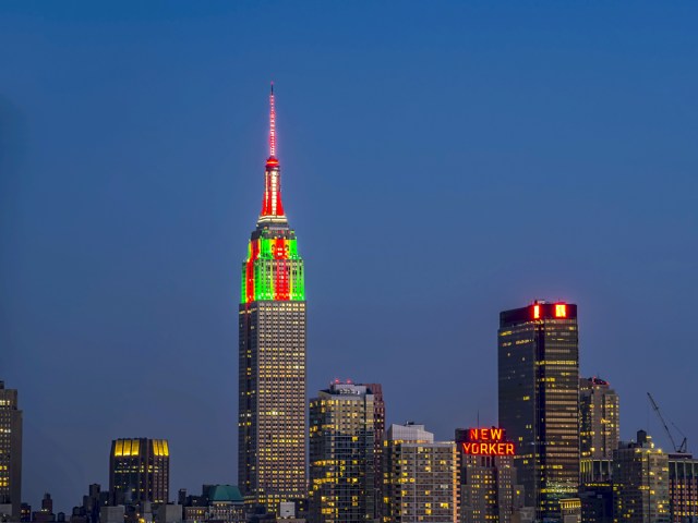 Empire State Building in New York City lit in red and green colors