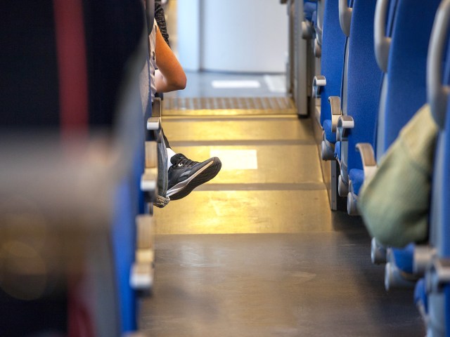 Passenger's foot poking into train aisle