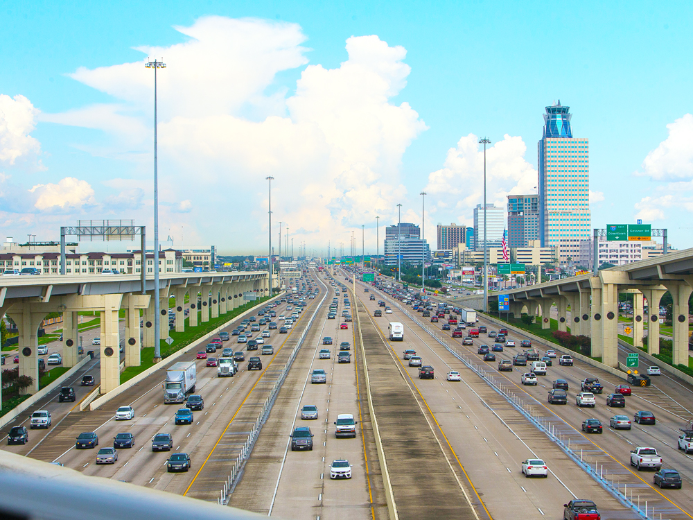 Traffic-filled I-10 with Houston skyline