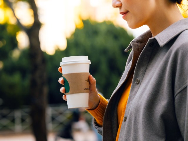 Person holding to-go coffee cup