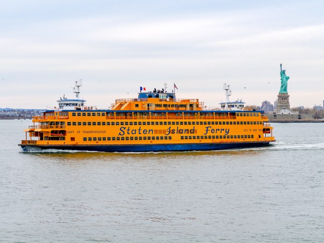 Staten Island Ferry cruising in New York Harbor with Statue of Liberty in background