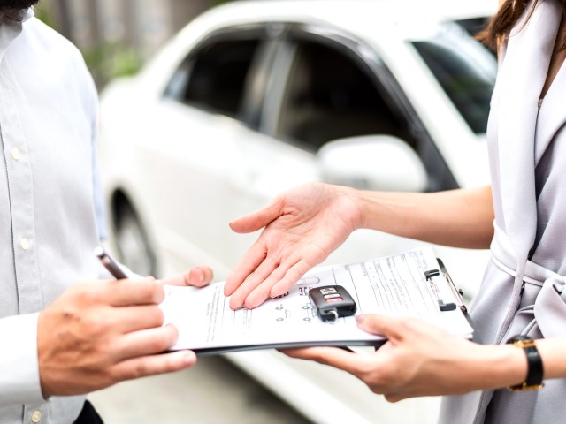 Customer signing rental car agreement