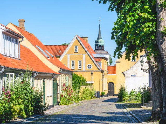 Quiet street with view of church tower in Ærø, Denmark